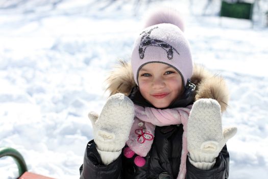 Beautiful little girl in winter park