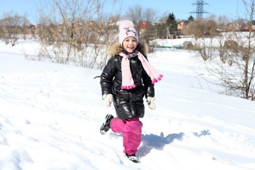Beautiful little girl in winter park