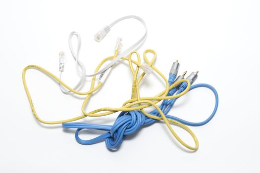 Assorted coloured electrical cables on a white background