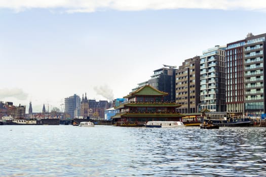 View at the Amsterdam central station from the water in the Netherlands