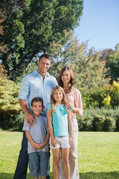 Family standing in the countryside smiling at the camera