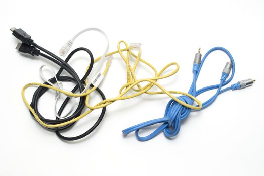 Assorted coloured electrical cables on a white background
