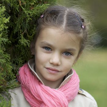 portrait of a beautiful girl in a pink scarf