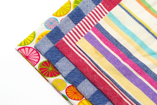 Coloured tea towels on a white background