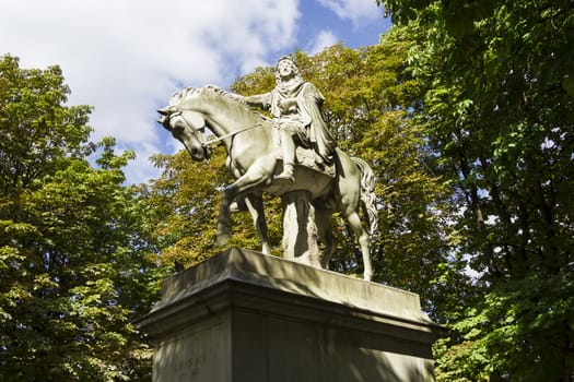 The statue of Louis XIII riding a horse in Place des Vosges, Paris, France