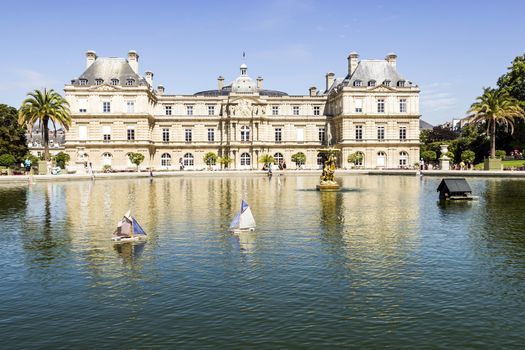 Traditional small wooden sailing boat in the pond of park Jardin du Luxembourg, Paris, France