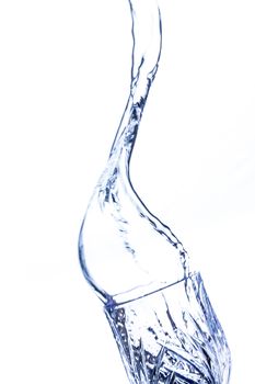 A beautiful shape created by the fluid motion of water splashing as it is thrown out of a glass