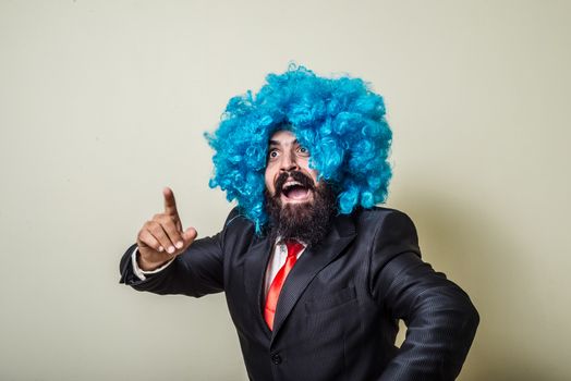 crazy funny bearded man with blue wig on white background