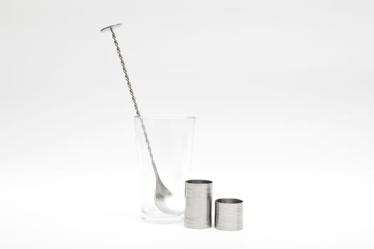 Various cocktail mixing utensils on a white background