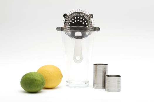 Various cocktail mixing utensils on a white background