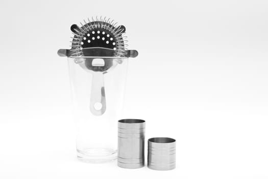 Various cocktail mixing utensils on a white background