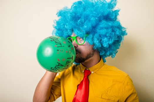 crazy funny young man with blue wig on white background