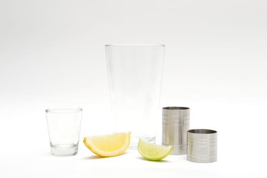 Various cocktail mixing utensils on a white background