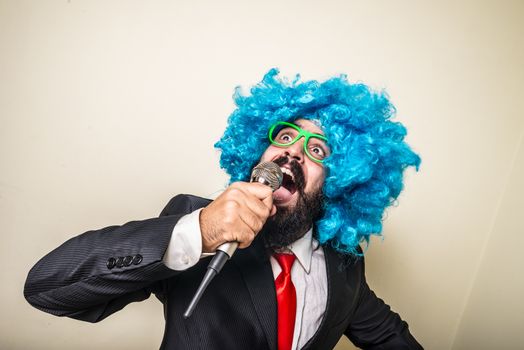 crazy funny bearded man with blue wig on white background