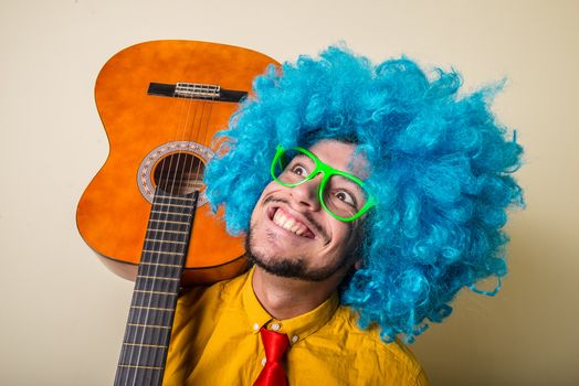 crazy funny young man with blue wig on white background