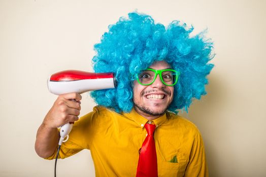 crazy funny young man with blue wig on white background