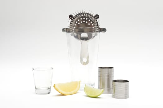 Various cocktail mixing utensils on a white background