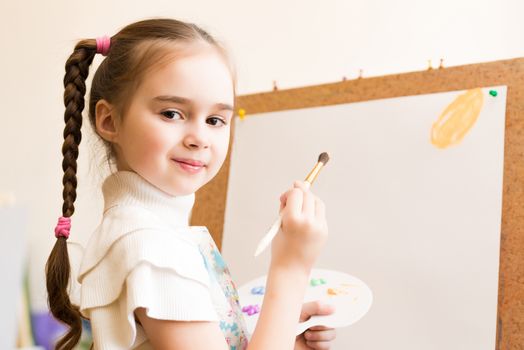 portrait of a girl standing next to his easel, a drawing lesson