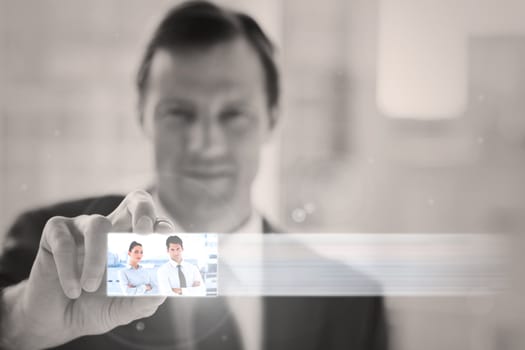 Classy businessman presenting digital interface of coworkers