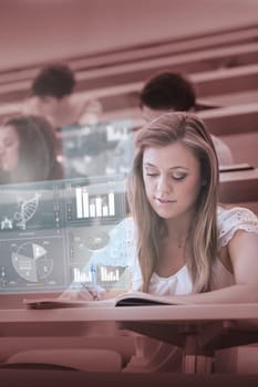 Focused college student working on digital interface in lecture hall