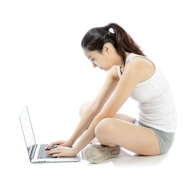 Attractive asian girl in her twenties isolated on a plein background shot in a studio