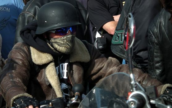 Lone biker rides through a crowd at a motorcycle event at Brighton,England.