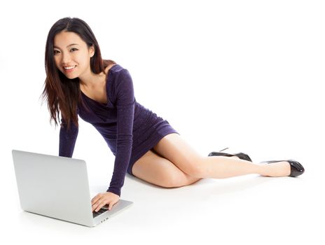 Attractive asian girl in her twenties isolated on a plein background shot in a studio