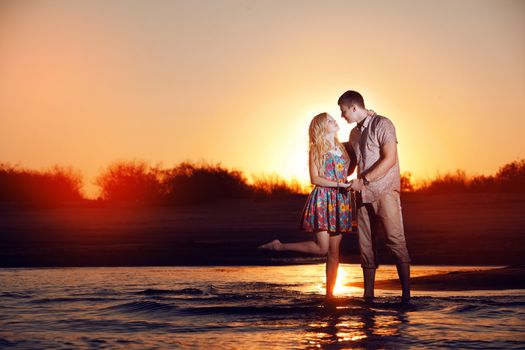 happy couple on the beach in the evening