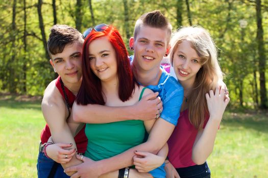 Young teenage group with colored shirts are having fun 