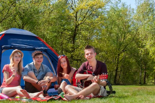 Young teenager group are having their holliday on a camping