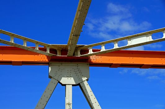 Beams of the bridge on a background of the blue sky