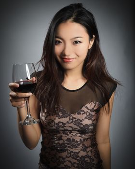 Attractive asian girl in her twenties isolated on a plein background shot in a studio