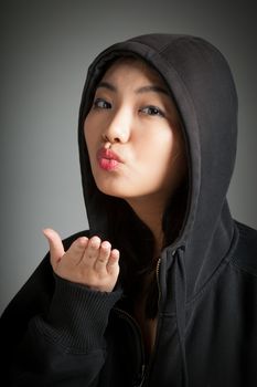 Attractive asian girl in her twenties isolated on a plein background shot in a studio