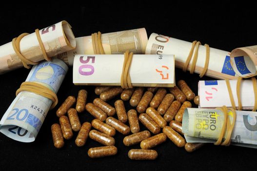 Some Pills And Money on a Black Background