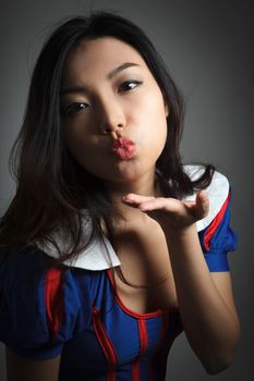 Attractive asian girl in her twenties isolated on a plein background shot in a studio