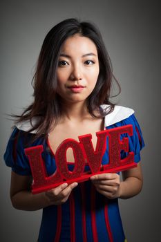 Romantic people in love shot in studio isolated on a grey background