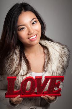 Romantic people in love shot in studio isolated on a grey background