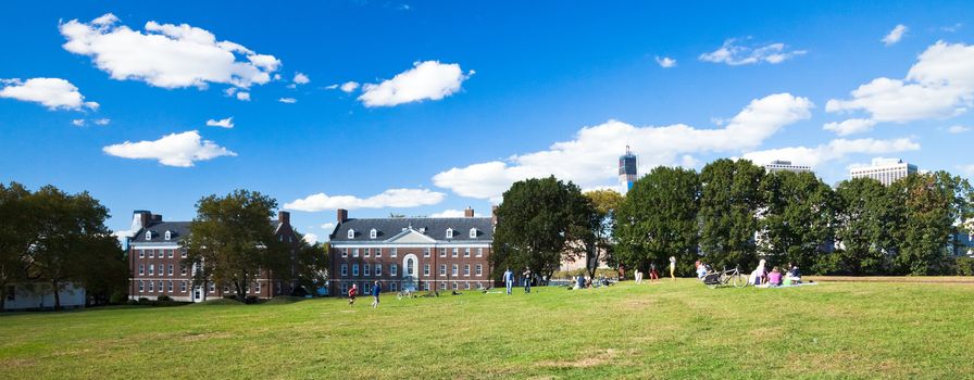 NEW YORK, USA-SEPTEMBER 23, 2012: Governors Island National Monument is a 172-acre (70 ha) island in Upper New York Bay and is open to the public for several months in the summer and early fall. Visitors are taking the walk around and can take the rest or picnics.