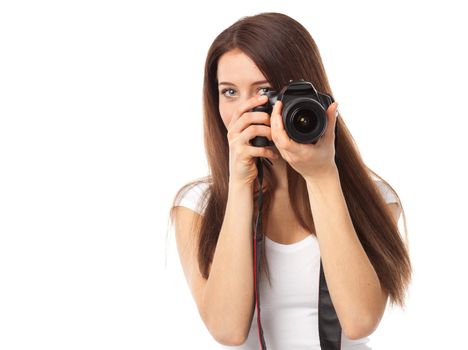 Young woman holding a camera and looking something, isolated on white