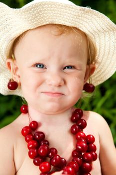 portrait od the child with cherry beads