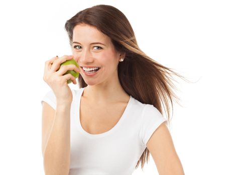 Young and cheerful woman eating a green apple, isolated on white