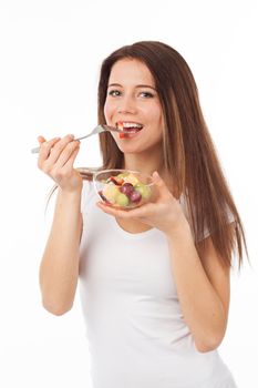Nice woman eating fruits with a fork, isolated on white