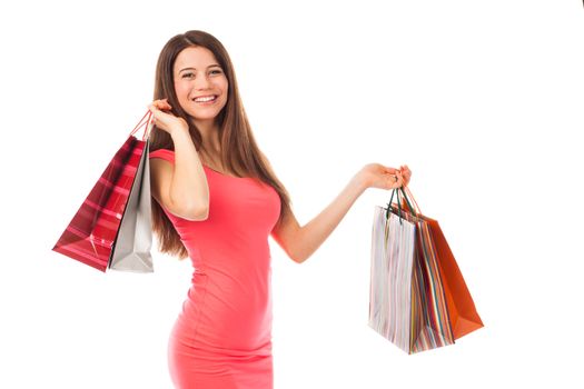 Portrait of a young woman holding shopping bags, isolated on white