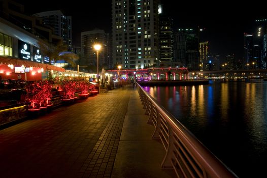 Bright lights Dubai marina scene at night