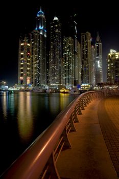 Bright lights Dubai marina scene at night