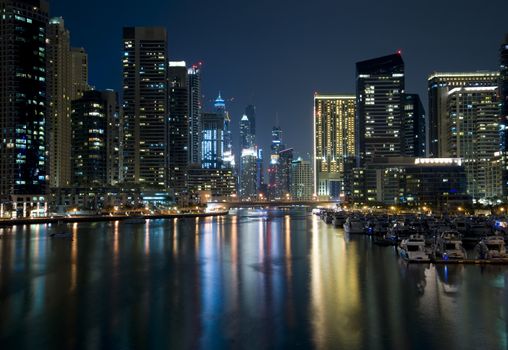 Bright lights Dubai marina scene at night