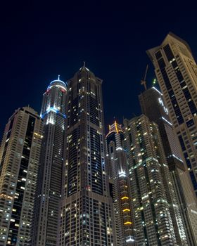 Bright lights Dubai marina scene at night