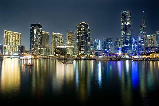 Bright lights Dubai marina scene at night