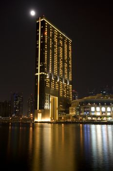 Bright lights Dubai marina scene at night