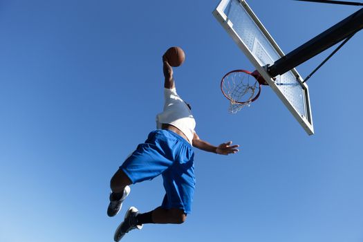 A young basketball player driving to the hoop with some fancy moves.